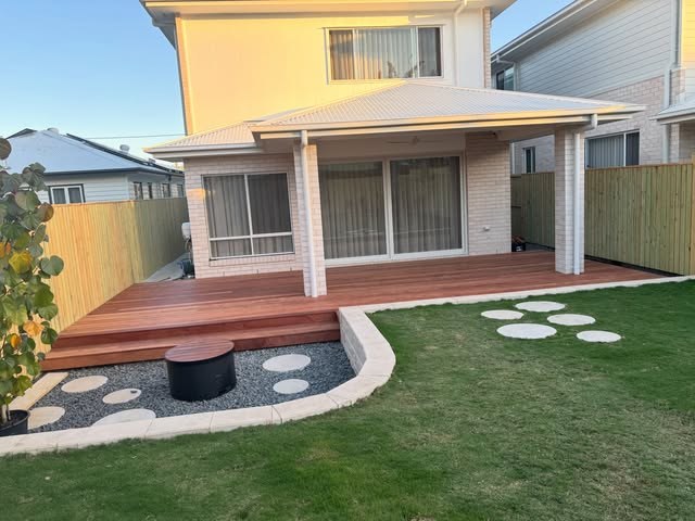 New hardwood deck stepping down into a landscaped rear yard